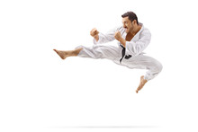 Man Performing Flying Kick In Martial Arts