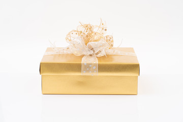 Wall Mural - Gold gift box on white background