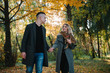 © Serhii - love, relationship, family and people concept - smiling couple having fun in autumn park