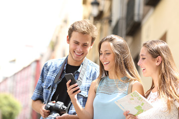 Wall Mural - Group of tourists locating using phone in the street