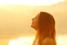 Profile Of A Woman At Sunset Breathing Fresh Air