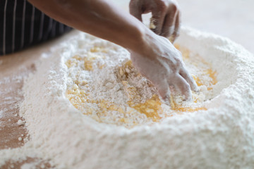 Making Handmade Noodles on wood background