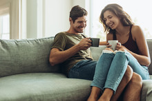 Couple Relaxing At Home With Coffee