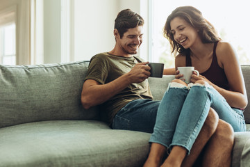 Couple relaxing at home with coffee