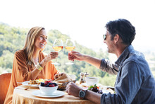 Couple Toasting Ros? Wine While Eating Brunch On Vacation