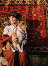 Portrait Of Cheerful Woman With Basenji Dog On Ornamental Background