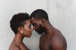 © Chelsea Victoria/Stocksy - Close up portrait of young black couple facing each other
