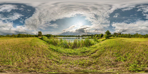Wall Mural - full seamless spherical hdri panorama 360 degrees angle view on grass coast of huge lake or river in sunny summer day and windy weather with beautiful clouds in equirectangular projection, VR content