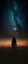 Dramatic And Fantasy Scene With Young Woman Looking Universe With Falling Stars.