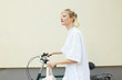 © Emotion Matters/Stocksy - Woman going to the city with her bike.