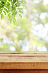 Wall Mural - Wooden table and blurred green nature garden background.