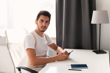 Young man wearing a back support belt. Lumbar brace, back support for back trauma or muscle back strain.