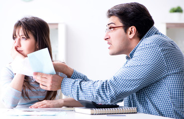 Young couple looking at family finance papers