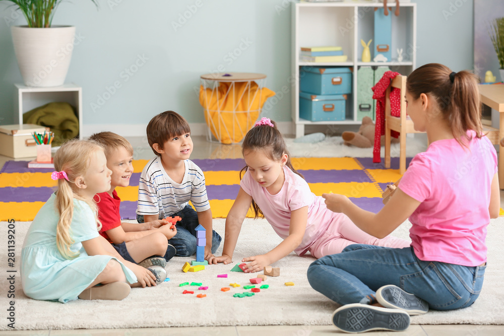 Cute little children learning letters in kindergarten