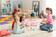 © Pixel-Shot - Cute little children learning letters in kindergarten