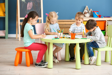 Sticker - Cute little children drawing in kindergarten