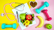 © millefloreimages - Healthy lifestyle prescription for good health concept flatlay with stethoscope, healthy food, and exercise equipment on modern pastel background.