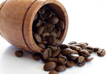 Closeup Of Miniature Barrel With Coffee Beans On White Background