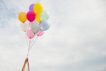 let it go, freedom hand and release concept. birthday balloon holding by happy beautiful women in su