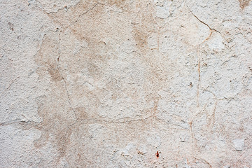 Texture of a concrete wall with cracks and scratches which can be used as a background