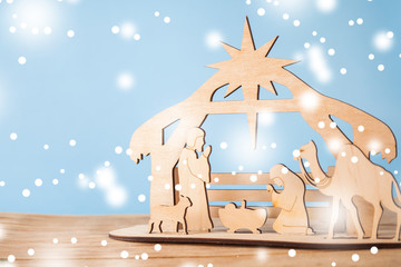 Christmas Nativity Scene of baby Jesus in the manger with Mary and Joseph in silhouette surrounded by the animals