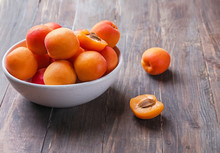 Delicious Fresh Ripe Apricots In A Bowl On The Wooden Table