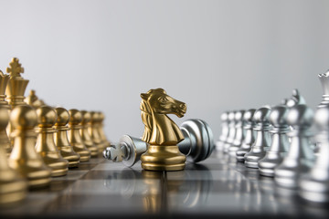 Chess (Knight wins the game) on white background. Success, business strategy, tactics, win, victory, winner, intellect, defeat, beat, knock or checkmate concept.