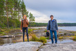 © Tatyana_Andreyeva - Middle aged man and young lady walking on northern lake shore in summer day. Tourists against picturesque landscape. Travelling and discovering distant places of Earth. Onega lake, Karelia, Russia
