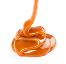 Pouring Sweet Caramel Sauce On White Background