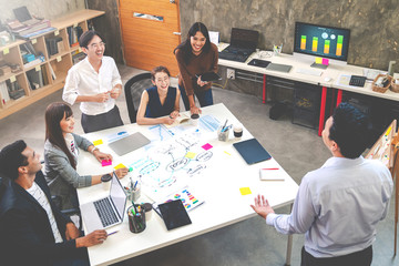 Top view of Asian creative team meeting, Presentation and Brainstorming. Happiness and success designer team are talking, brainstorm and discussion for target goal. Soft mood and tone.