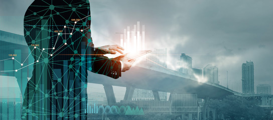 Poster - Double exposure of graph chart and network connection on businessman using tablet analyzing sales data and economic growth on citiy background. Business and digital technology.