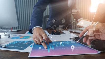 Poster - Businessman hand pointing at business report document during discussion and analyzing sales data economic growth with graph financial diagram, Marketing, teamwork, business planning and strategy.
