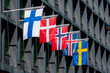 Five Nordic flags on flagpoles with EU flag. Denmark, Sweden, Norway, Finland, Iceland