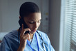 Female doctor talking on mobile phone in hospital