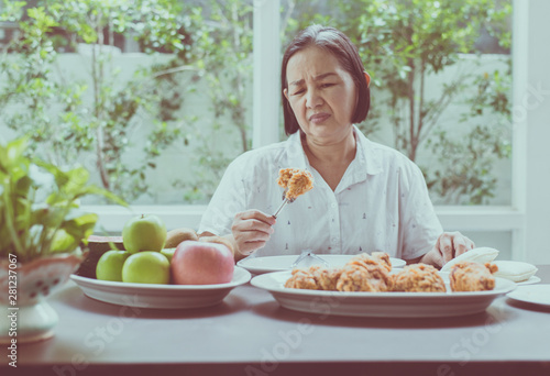 Cuadros en Lienzo Senior asian woman feeling unhappy and bored meal,Elderly healthy concept