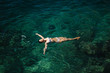 © Aleksandr - Sexy woman in bikini lying on the water. Attractive young woman enjoying summer sun. Beautiful lagoon. Woman swin in the sea. Top view