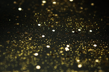 Wall Mural - Golden sparkles on black background. Festive concept. - Image