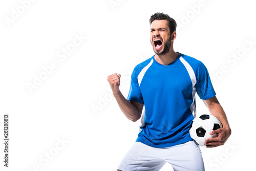 Fotografía excited soccer player with ball and clenched hand Isolated On White