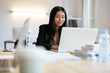 © Westend61 - Young Asian woman working in office using laptop
