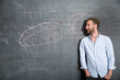 © Westend61 - Young man looking at drawing at blackboard