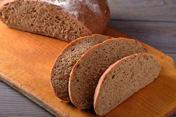 Rustic bread loaf on dark background. Top view