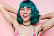 © Lucas Ottone/Stocksy - Portrait of happy teen with green hair