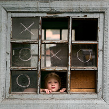 Girl Looking Through Old Broken Window