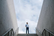 © JIACHUAN LIU/Stocksy - Business Man Walking On Top Of The Stairs