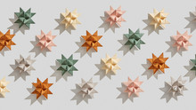 Multicolored Paper Origami Stars Presented On A Gray Background With Shadows . Handcraft Pattern. Flat Lay