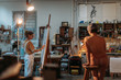© Javier Pardina/Stocksy - Woman painting model on canvas at her studio