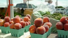 Punnets Of Fresh Peaches Stacked High Ready For Sale At The Local Farmers Market In Bandon Oregon