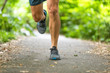 © Maridav - Running man runner athlete workout jogging outdoors on city park path with running shoes closeup of feet and legs.