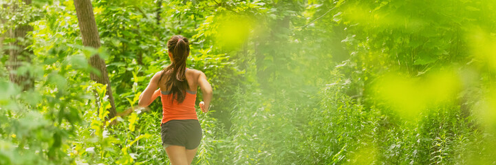 Wall Mural - Run panoramic fit active lifestyle of runner woman running in summer background banner outdoor in city park green nature. Athlete training.