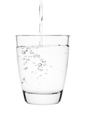 Wall Mural - water pouring into a tumbler glass isolated on white background. with clipping path.